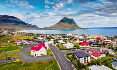 Door stickers Kirkjufell View from flying drone. Splendid morning cityscape of Grundarfjordur town with Kirkjufell Mountain on background. Aerial view of Grundarfjordur Church, Iceland, Europe. Traveling concept background.