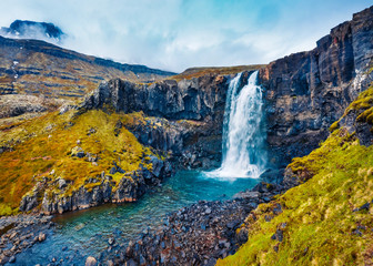 View from flying drone of Gufufoss (Gufu Waterfall). Wonderful midnight sun scene of typical...