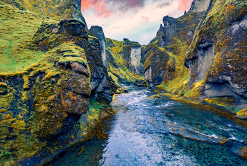 View from flying drone of Fjadrargljufur canyon and river. Dramatic summer sunrise on South east Iceland, Europe. Beauty of nature concept background.