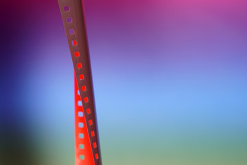 Fototapeta premium Film of an analogue camera with colorful background photographed in the studio