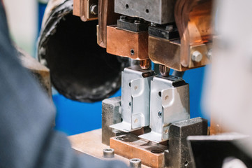 Spot welding machine Industrial automotive part in factory. Operator working in industry .
