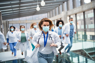 Group of doctors with face masks running, corona virus concept.