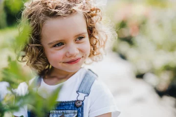 Foto op Plexiglas Portrait of small girl standing in the backyard garden. © Halfpoint