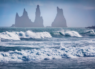 Storn on Atlantic ocean. Breathtaking morning view of Reynisdrangar cliffs. Impressive summer scene of Iceland, Vik location, Europe. Beauty of nature concept background.