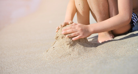 Baby makes sand castles on the beach