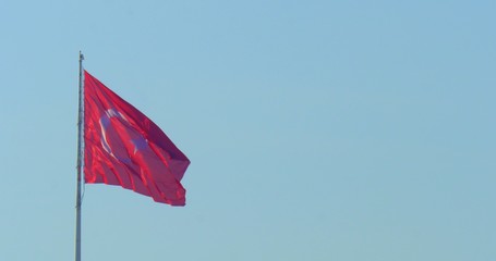 Turkish flag waving with wind at blue sky.