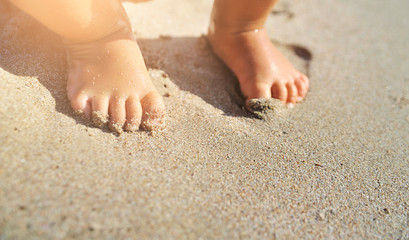  baby feet on sand.