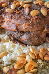 Grilled lamb thigh,on durum wheat or frikeh or rice and nuts top view on a dinner table.
