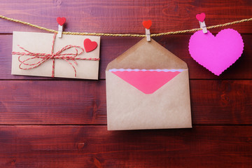 Valentines day concept with envelopes and heart shaped card hanging on a rope