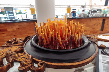 Fototapeta na wymiar Bacon on bread sticks in glasses delicious traditional food on wedding party