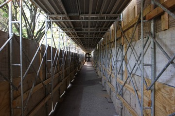 Protective scaffolding for pedestrians passing by skyscaper under construction