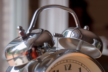 Silver analog alarm clock.