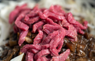 Sliced onions and meat, ingredients for goulash.