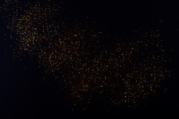 Orange festive abstract blurred background for Christmas. Orange circles bokeh on black background.