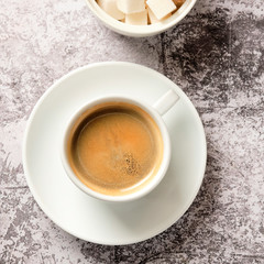 Cup of americano coffee for breakfast. A cup of black coffee in a white cup, shot from above, with copyspace. Food and drink concept.