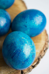 blue Easter eggs on a wooden stand, laid out for text placement