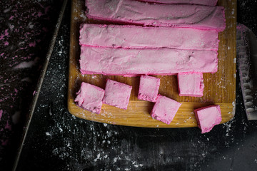 Pink marshmallows on a cutting board