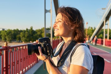 Mature woman photographer with camera taking photo picture