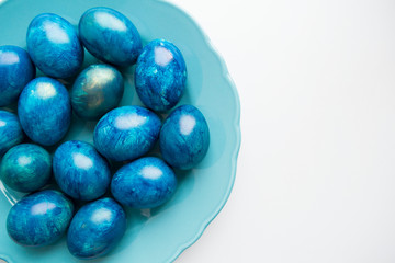 blue eggs laid on a blue plate on the table for Easter