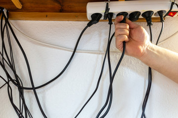 Electrical cable tangle under desk.