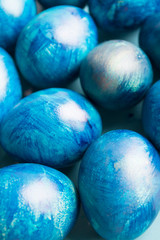 blue eggs with a tint on a white background for Easter