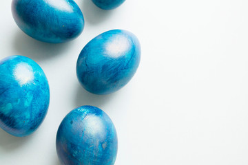blue eggs with a tint on a white background for Easter