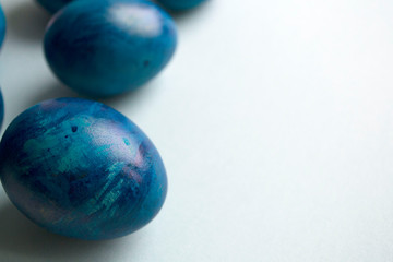 blue eggs with a tint on a white background for Easter