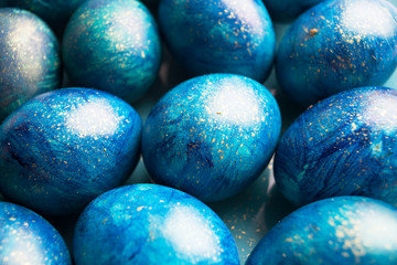 blue eggs with a tint on a white background for Easter