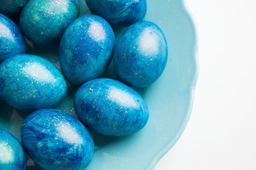 blue eggs laid on a blue plate on the table for Easter