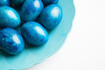 blue eggs laid on a blue plate on the table for Easter