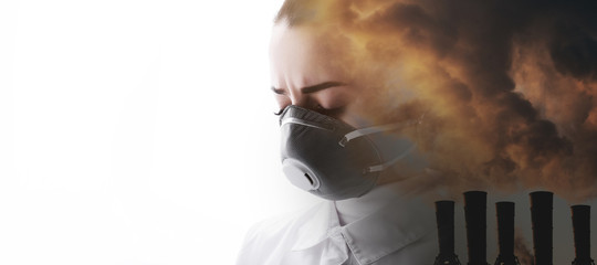Double exposure of female face and factory chimneys polluting air. Portrait of young sad woman in protective respirator. Girl wearing medical mask. Free space for text.