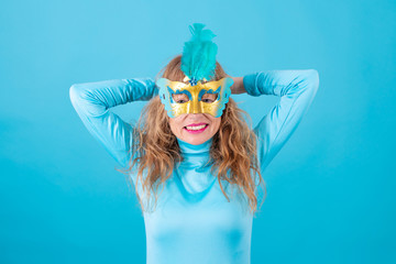 portrait of senior adult woman with carnival chewing isolated on color background