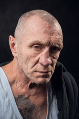 Closeup portrait of an old homeless alcoholic man