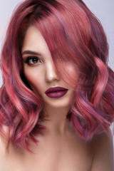 Fototapeta premium Beautiful girl with multi-colored hair and classic make-up and hairstyle. Beauty face.