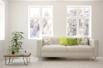 Stylish room in white color with sofa and winter landscape in window. Scandinavian interior design. 3D illustration