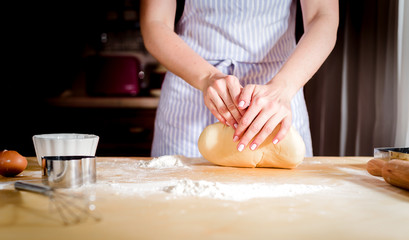 fingers on dough, chef kneads dough for baking, concept cooking, bakery