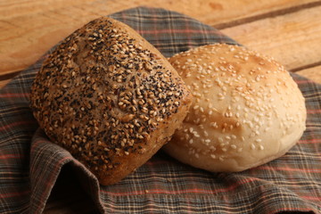 delicious bread rolls on colored background