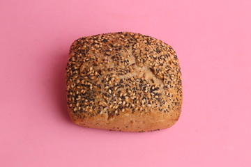 delicious bread rolls on colored background