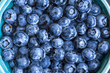 Blueberries floating in water with bubbles. Fresh blueberries background with copy space for your text. Vegan and vegetarian concept.Texture blueberry berries close up