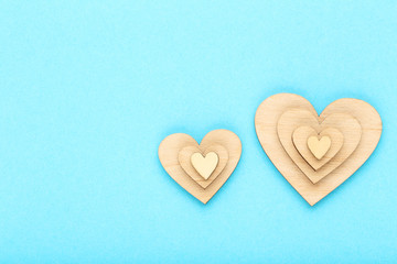 Brown wooden hearts on blue background