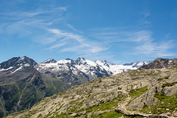Fototapeta na wymiar Hiking through spectacular mountain landscape of Gran Paradiso Natural Park.