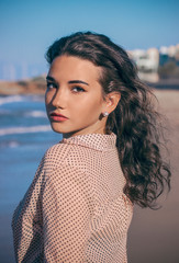 a girl stand at the beach