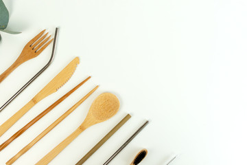 Eco friendly bamboo cutlery set and eucalyptus leaves on a white background. Zero waste concept.