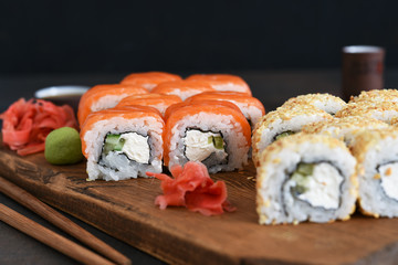 Different types of sushi served on a wooden board. Sushi menu. Japanese food.
