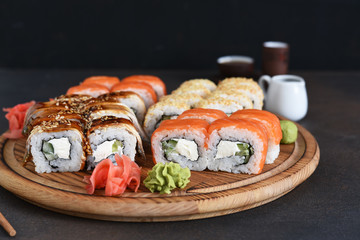 Different types of sushi served on a wooden board. Sushi menu. Japanese food.