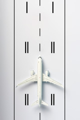 Aerial view of the airplane on airport runway background. Summer travel and aerospace industry...