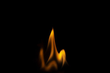 Fiery background. Flames of fire in the dark. Flame texture. Tongues of fire rise smoothly. A simple background of yellow shades. Burning gel for ignition. Ignition of vapors. Fire is danger.