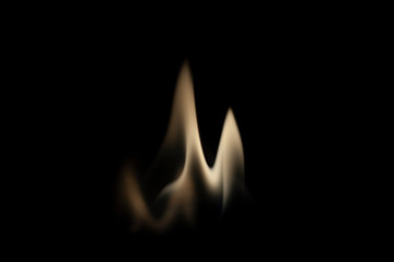 Fiery background. Flames of fire in the dark. Flame texture. Tongues of fire rise smoothly. A simple background of yellow shades. Burning gel for ignition. Ignition of vapors. Fire is danger.