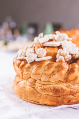 Close up of traditional holiday eastern Orthodox church bread with decoration on table.