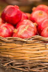 Pomegranates in basket at Market stall at Campo de' Fiori Market, Rome, Italy.